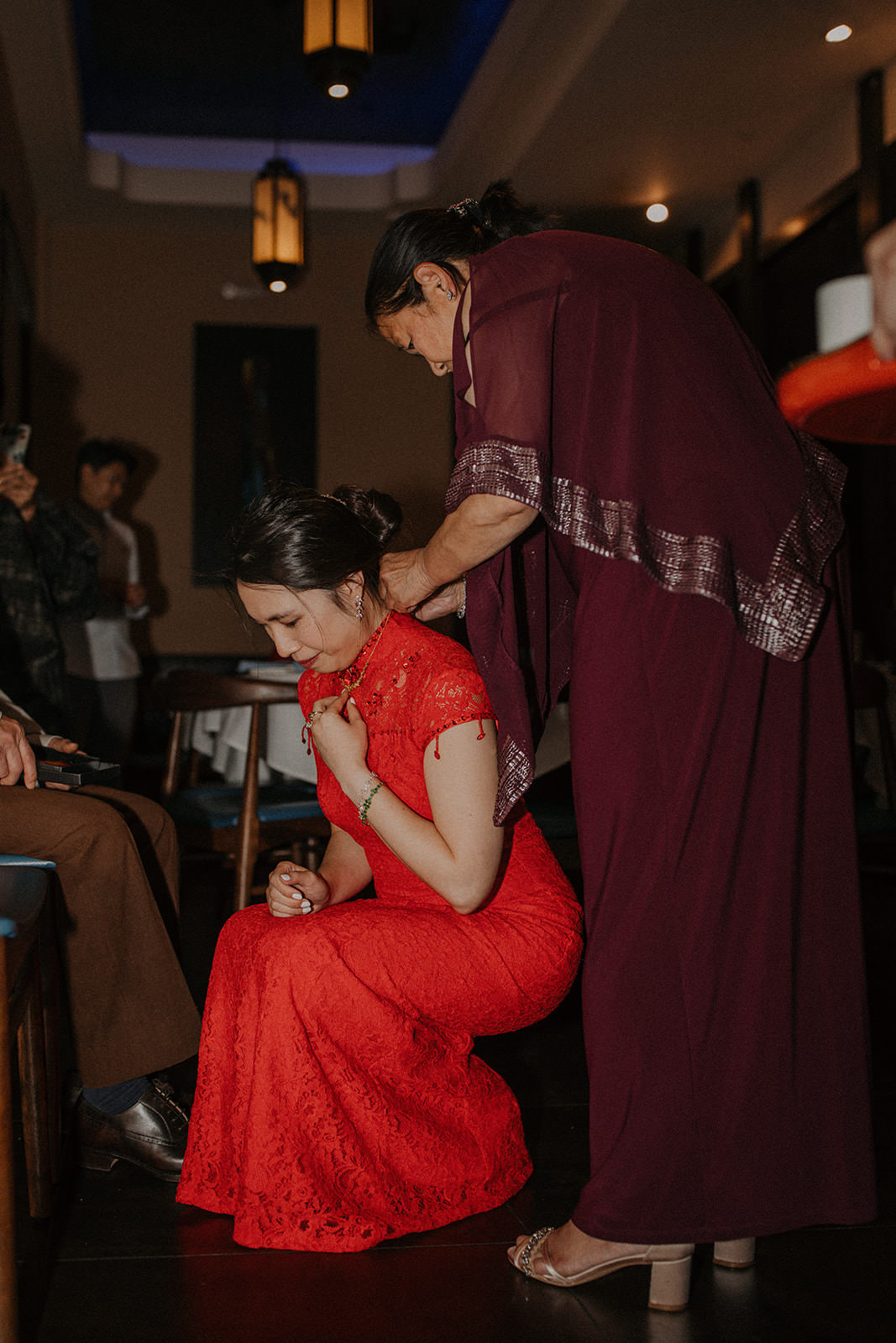 Brides mother presenting gift at tea ceremony