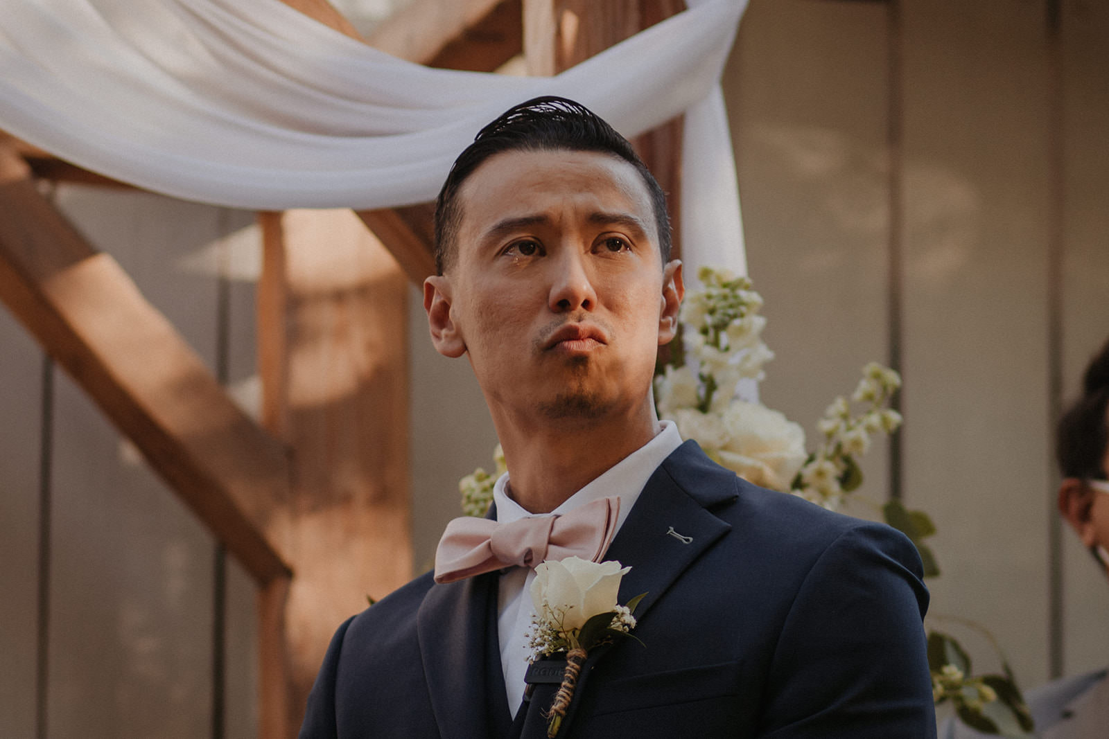 Groom getting emotional seeing bride walk down the aisle at the homestead in oak glen.