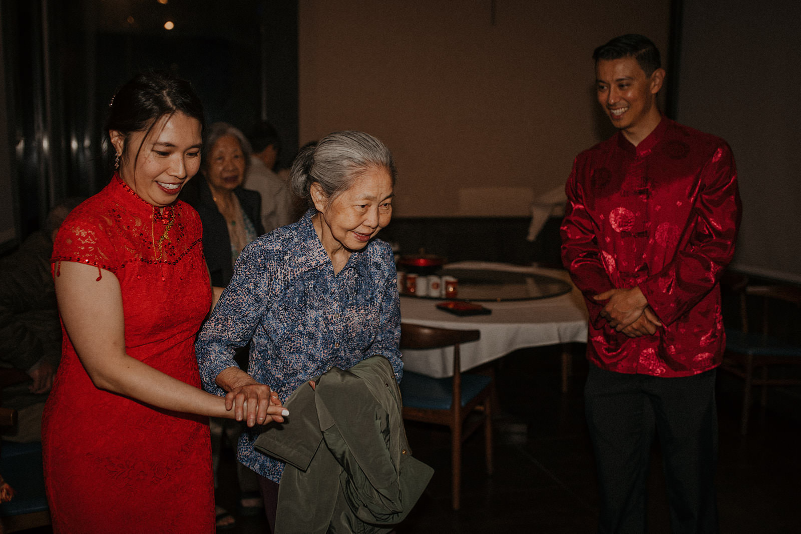 Bride escorting grandmother at tea ceremony