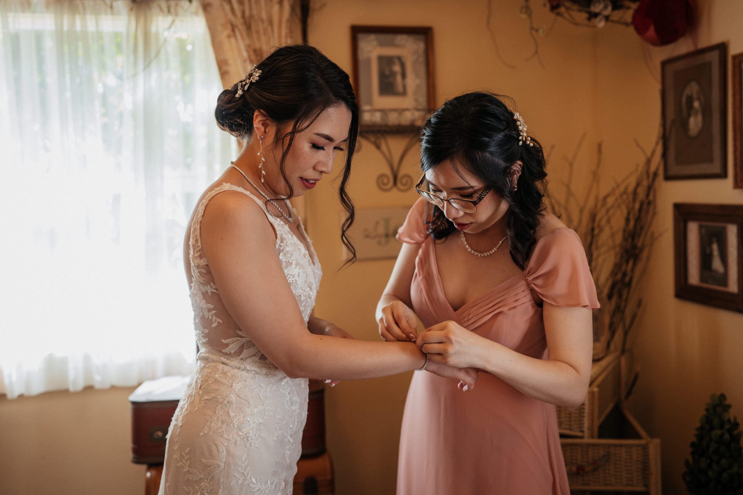 Maid of honor helping bride get ready at the homestead.