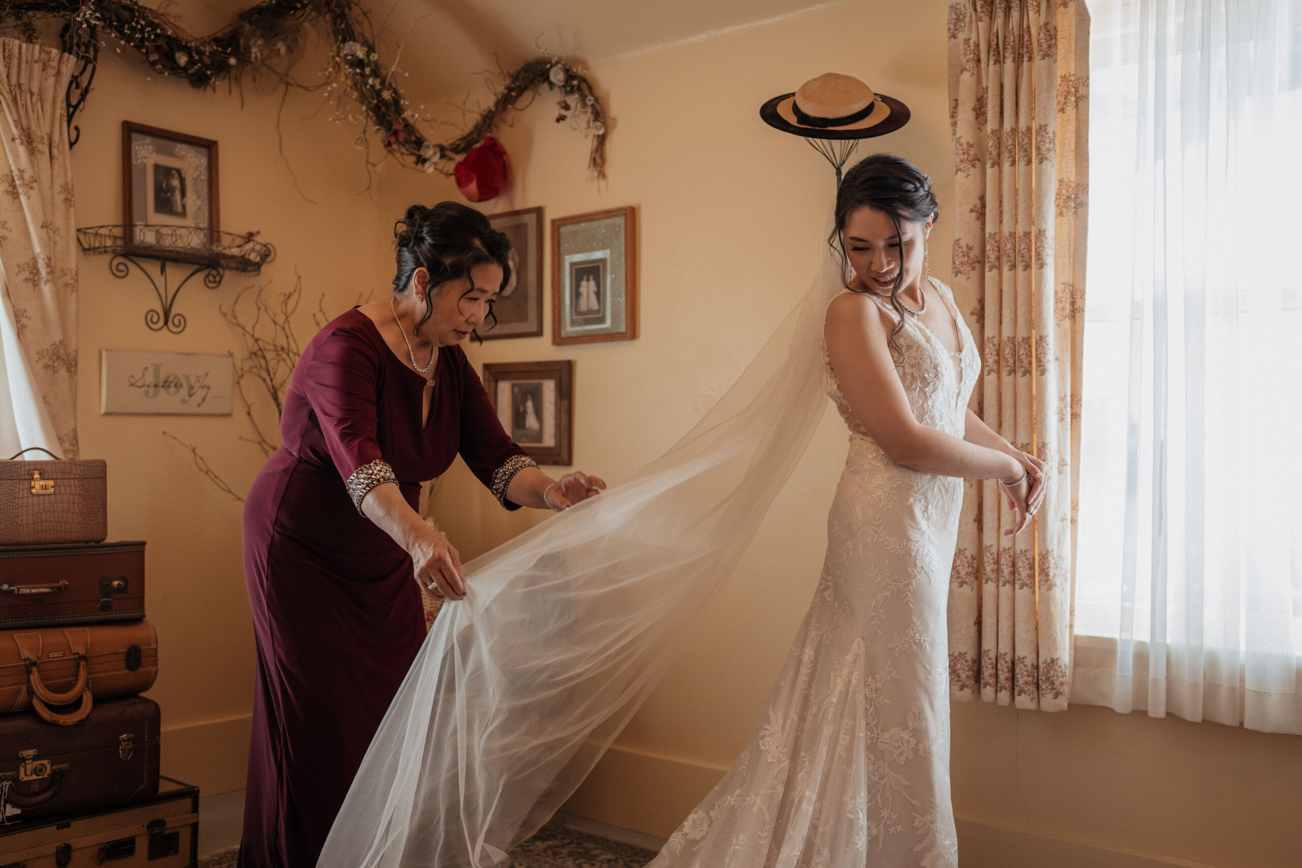 Brides mother fixing veil before wedding at the homestead.