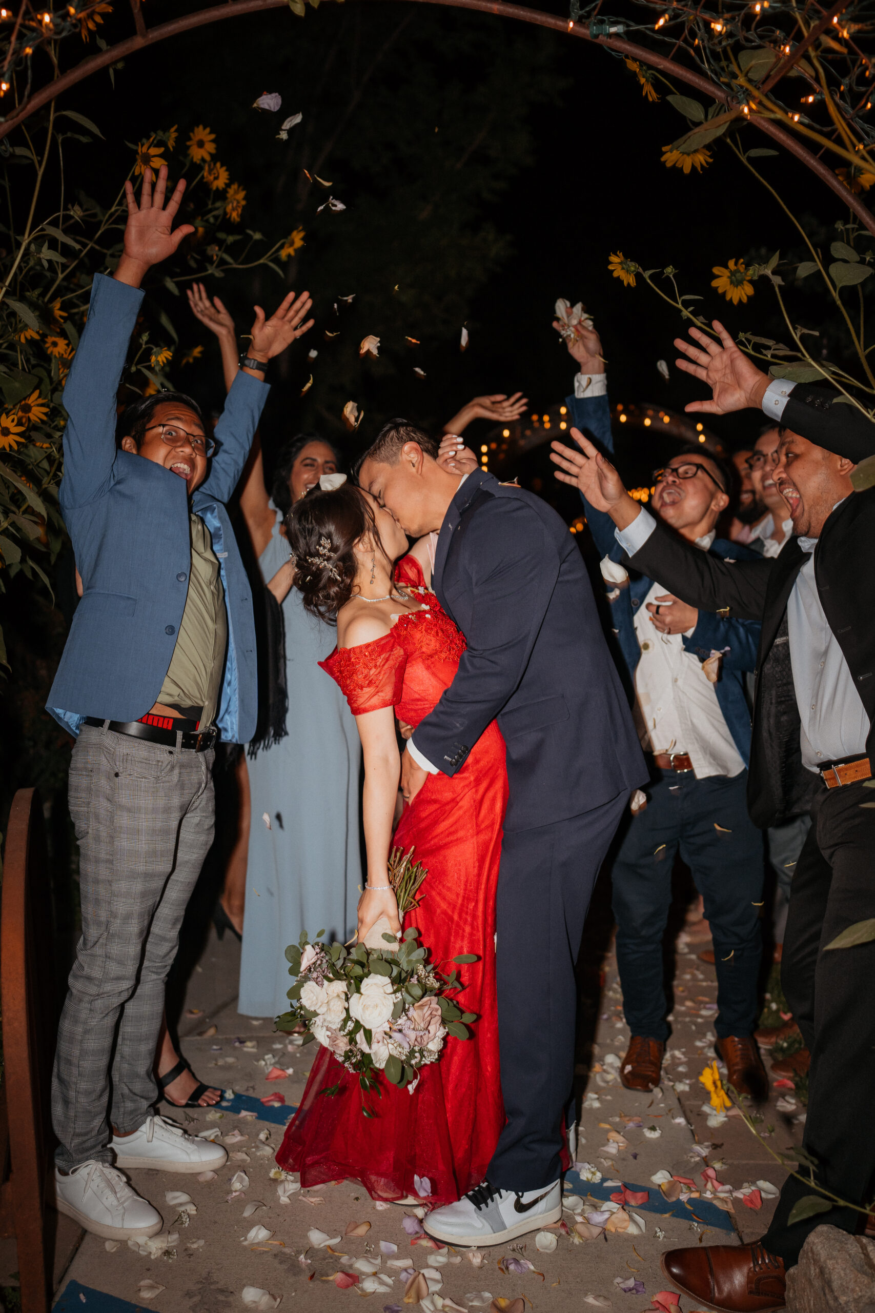 Bride and groom kissing during their grand exit at the homestead in oak glen.