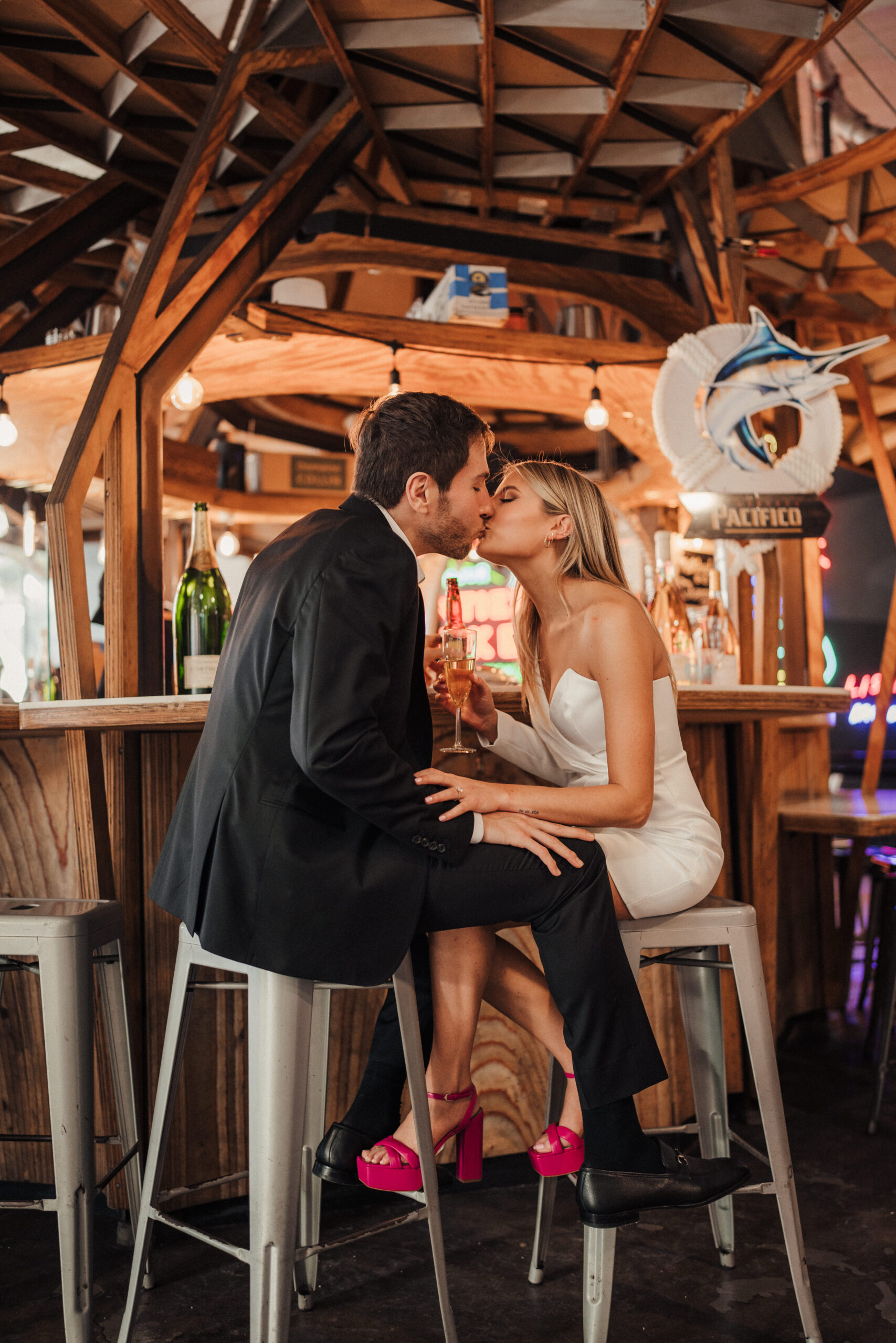 Engaged couple sits at bar at Grand Central Market LA for engagement photos