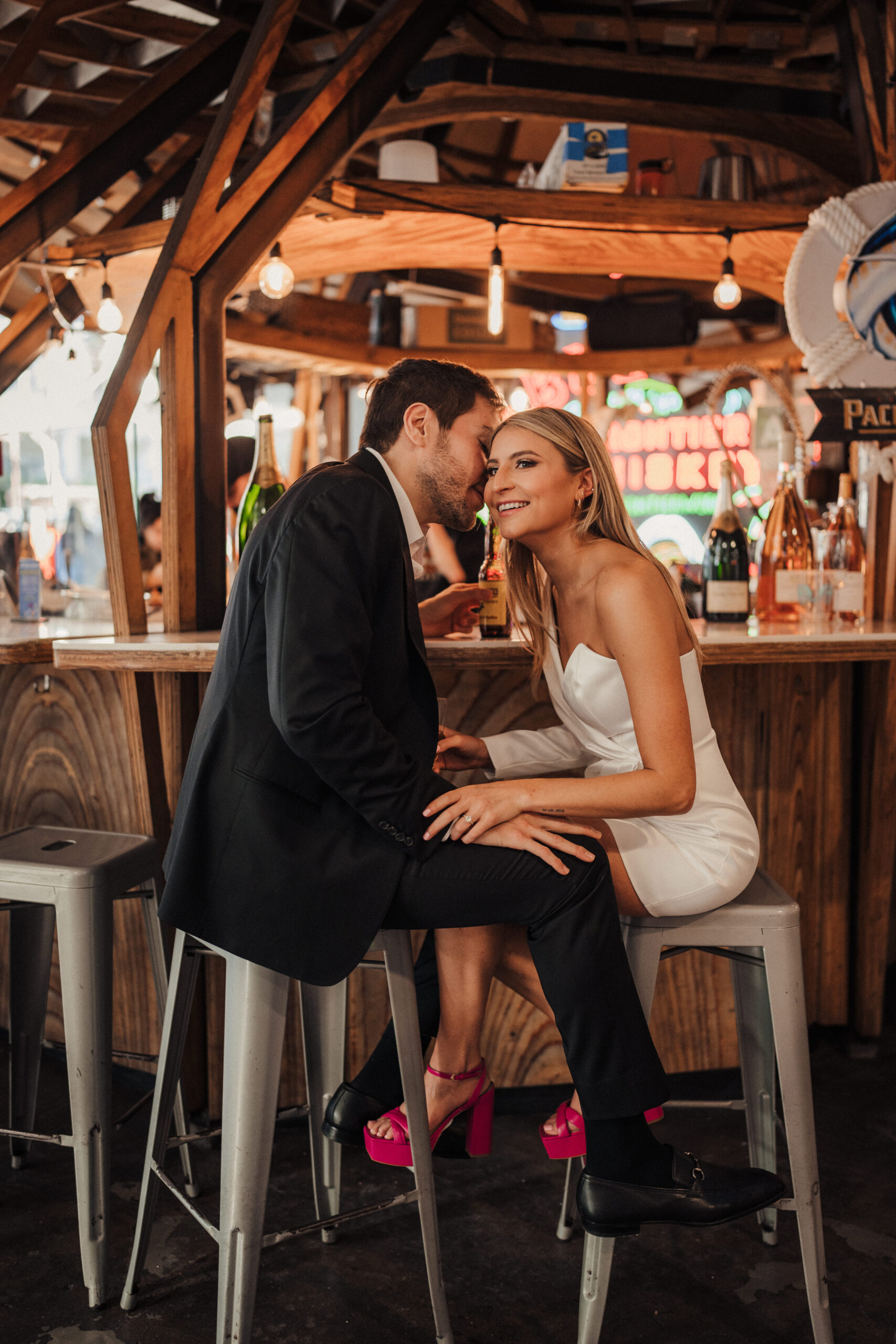 Engaged couple sits at bar at Grand Central Market LA for engagement photos