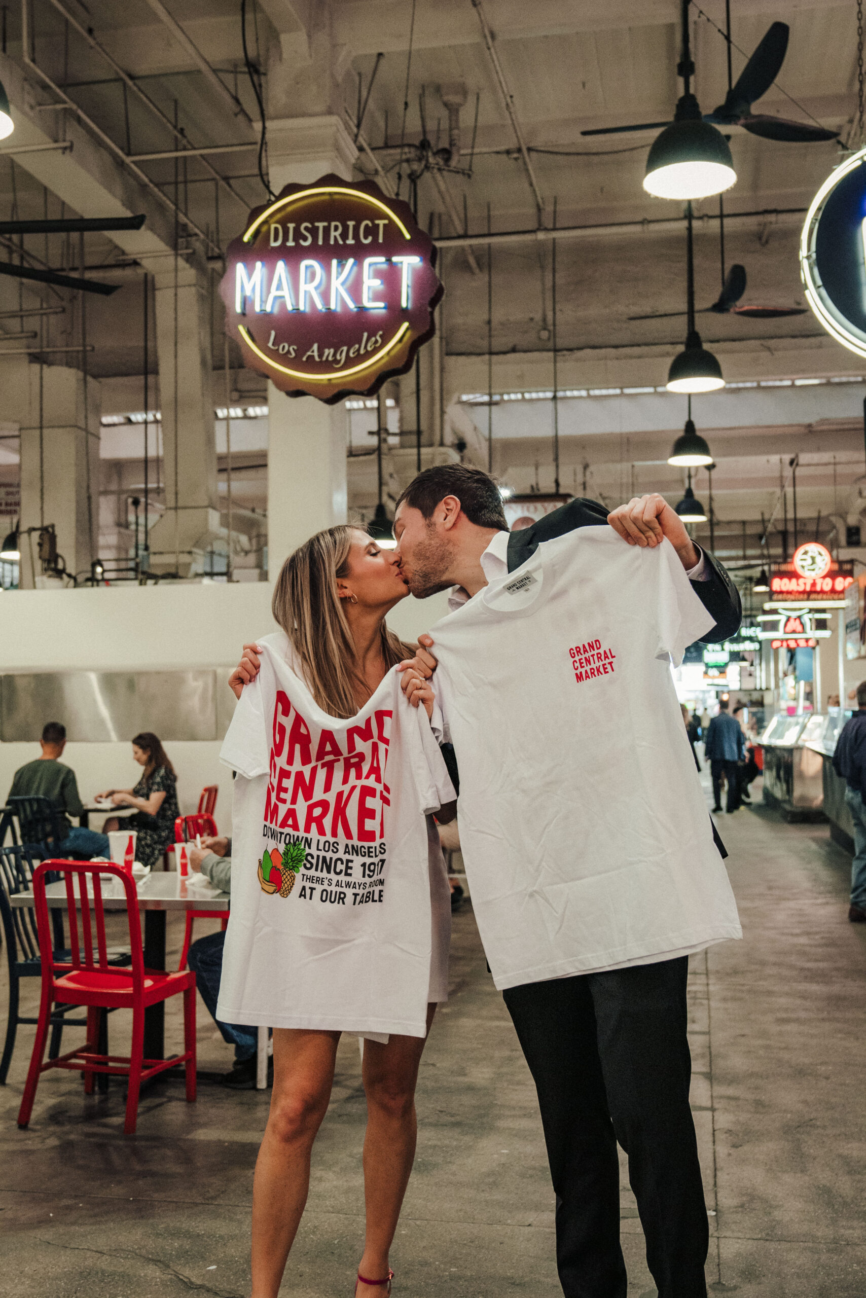 Engaged couple takes engagement photos at Grand Central Market in Downtown LA