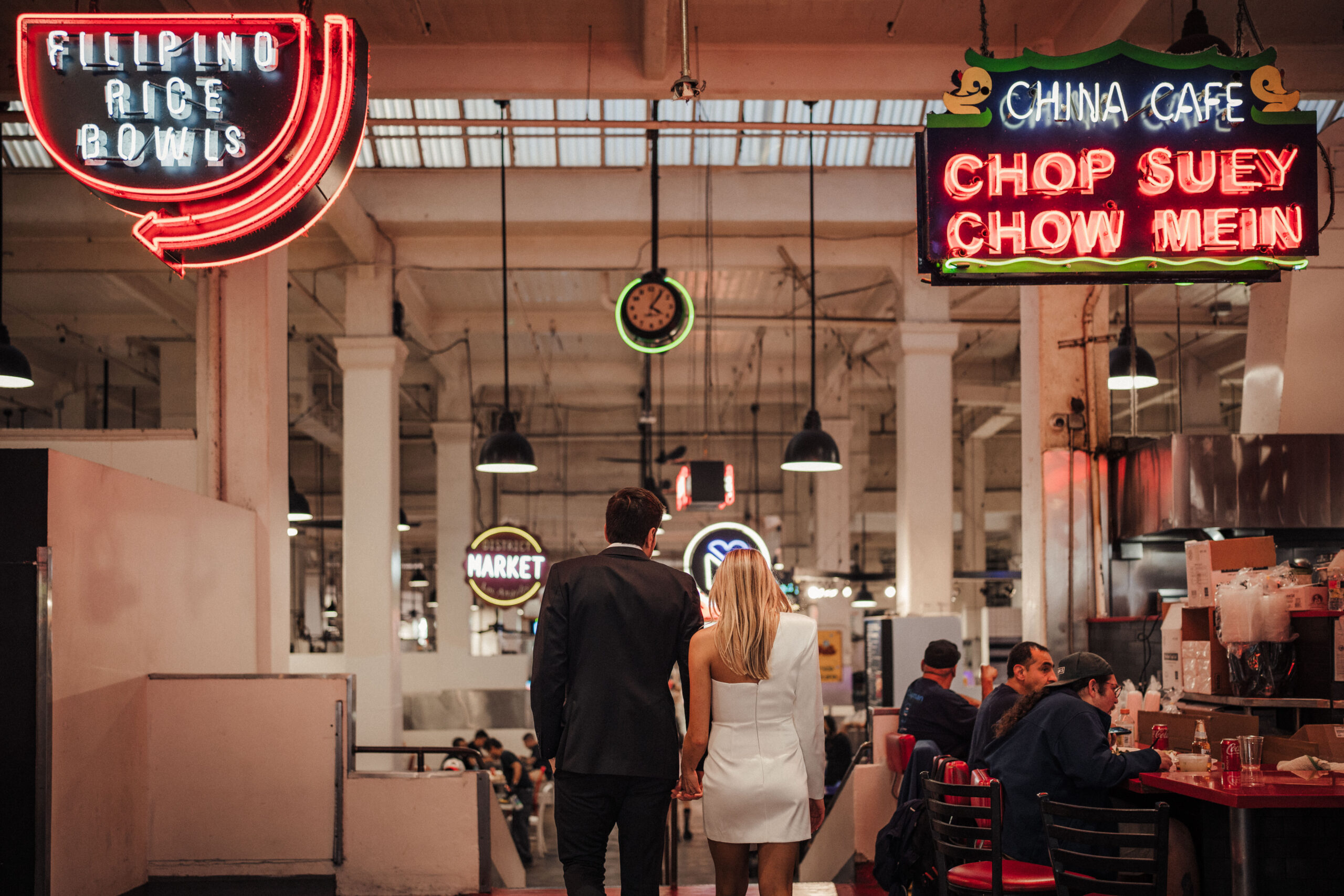 Engaged couple walks through Grand Central Market LA for engagement photos 