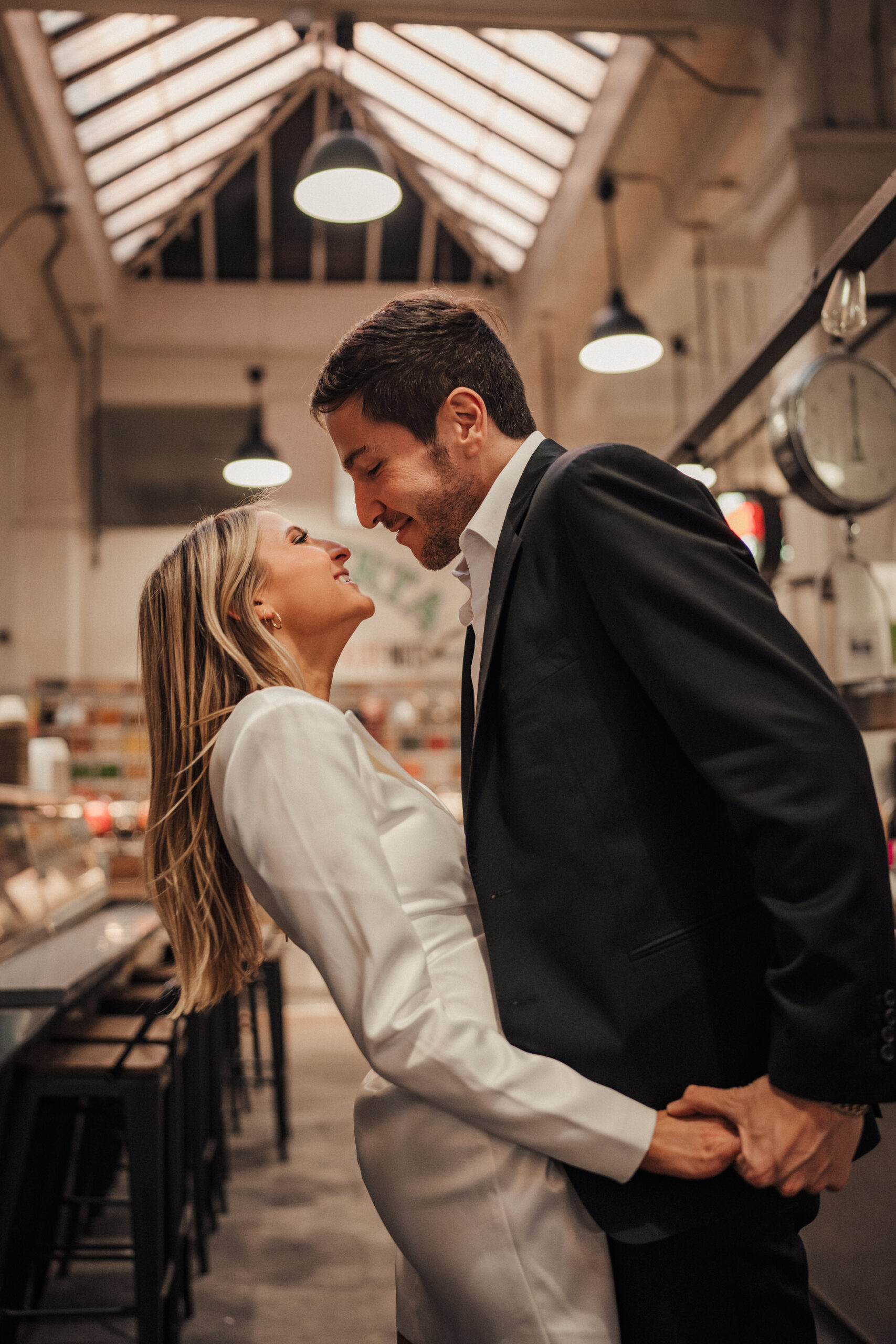 Engaged couple takes engagement photos at Grand Central Market in Downtown LA