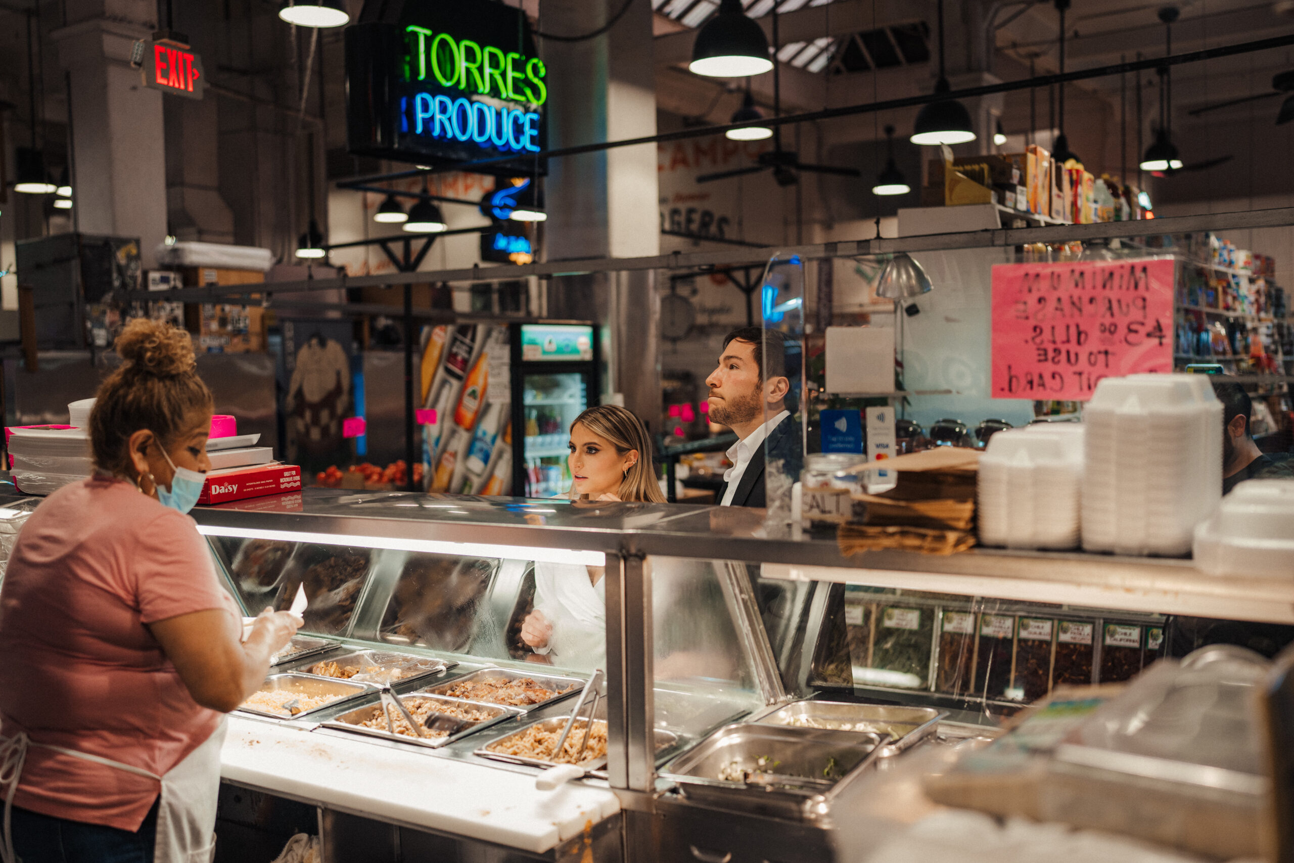 Engaged couple takes engagement photos at Grand Central Market in Downtown LA 