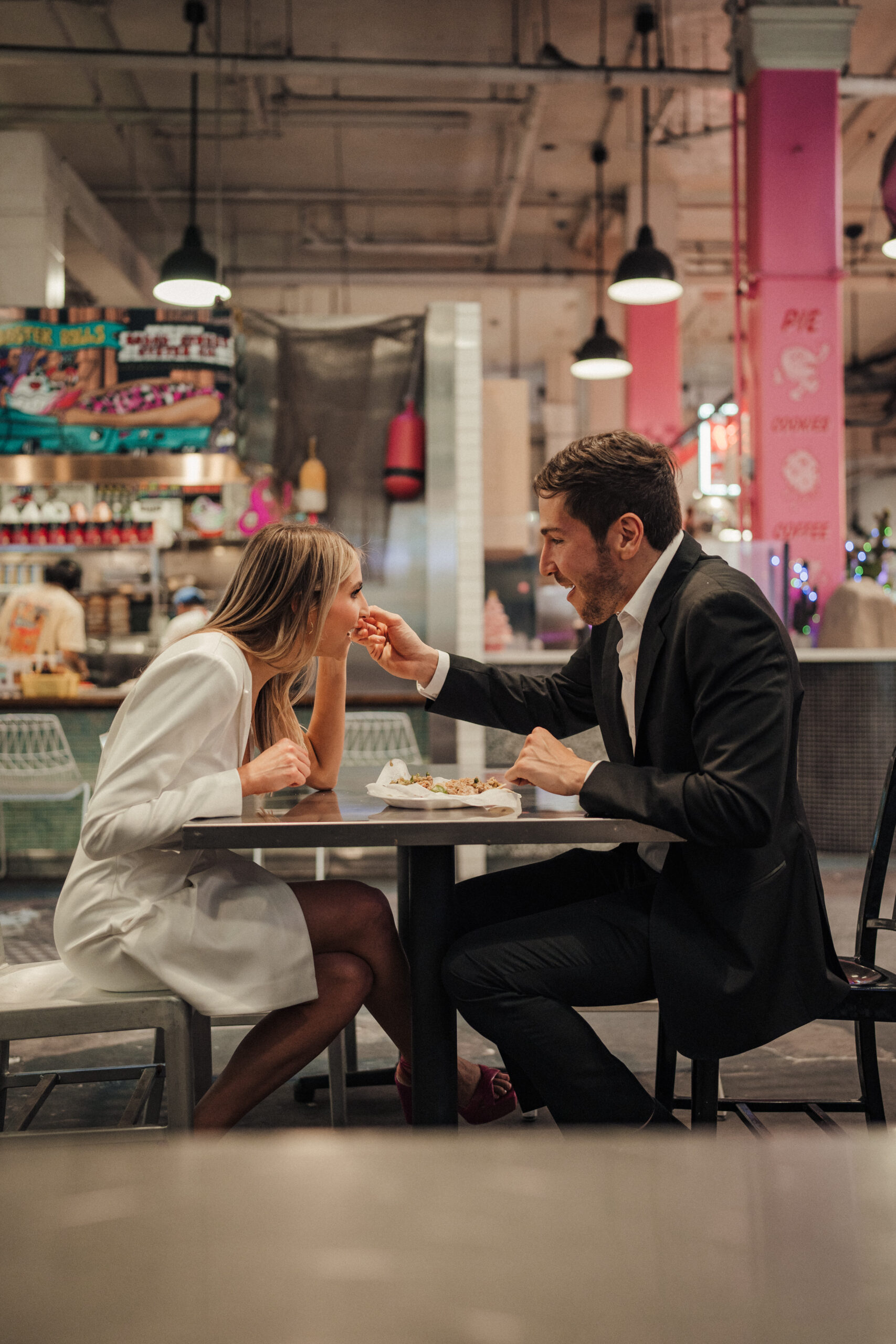 Engaged couple eats tacos together for their engagement photos at Grand Central Market in Downtown LA