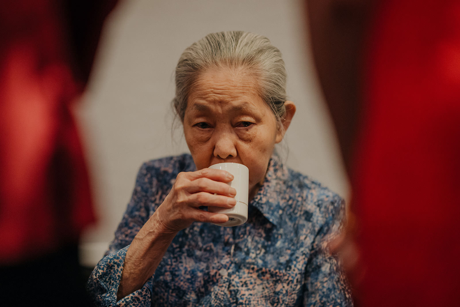 Grandmother enjoying tea at tea ceremony.