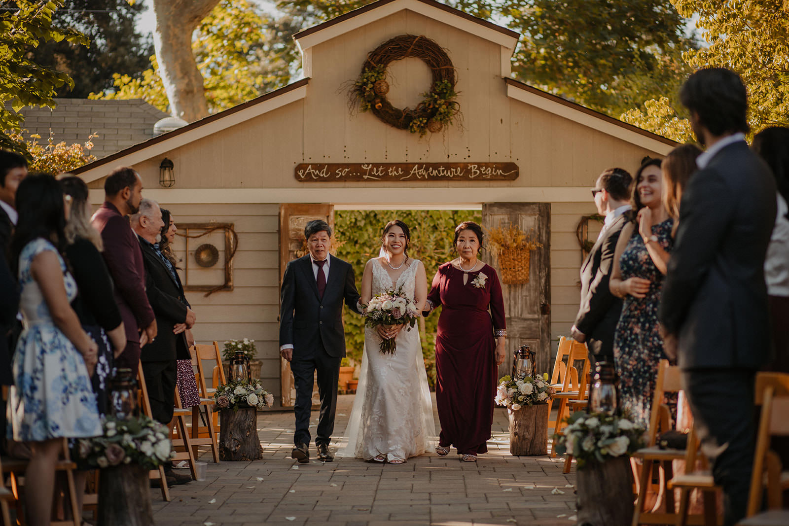 Bride entering ceremony with parents at the homestead in oak glen.