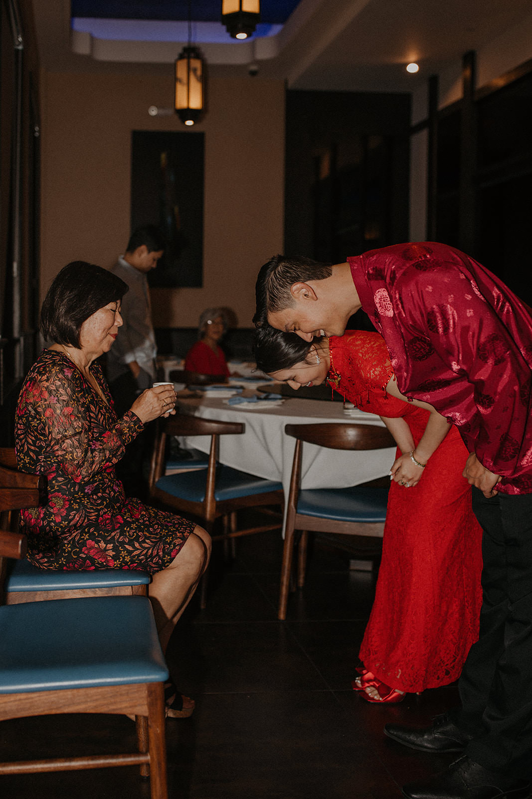 Couple greeting grooms mother at tea ceremony