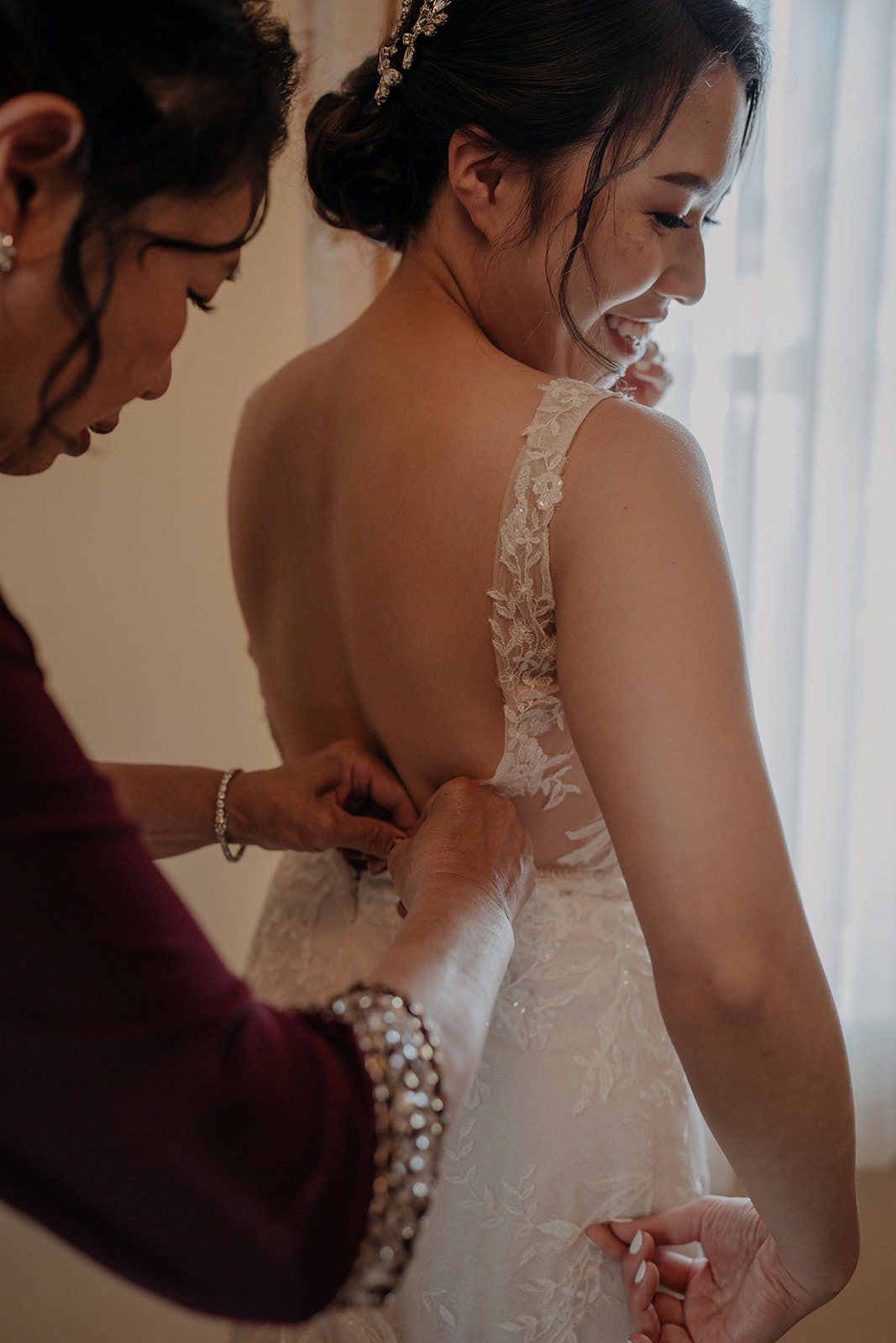 Brides mother helping with dress at the homestead in oak glen california