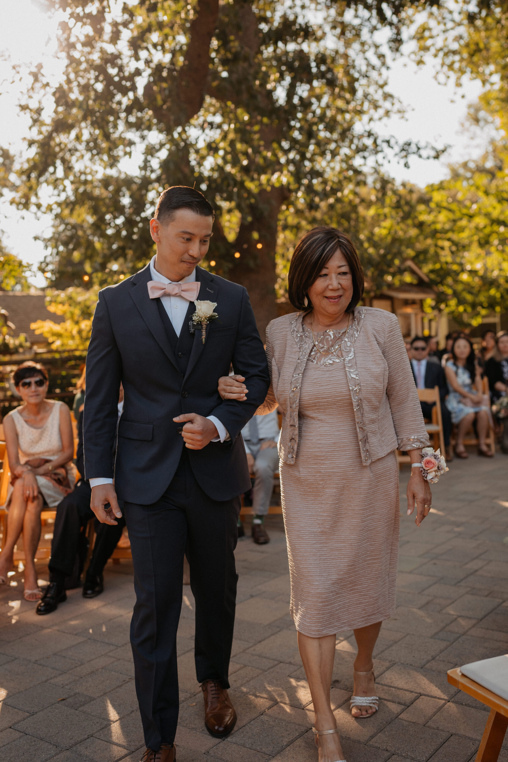 Groom walking his mother down the aisle at The Homestead ceremony.