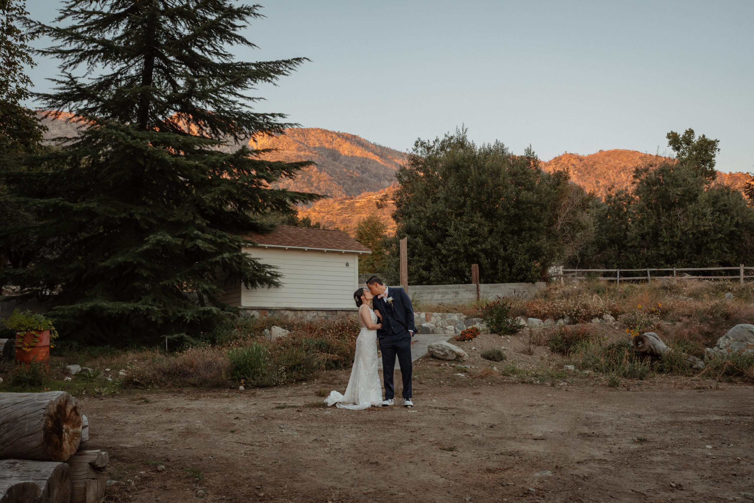 The bride and groom in front of the oak glen mountains