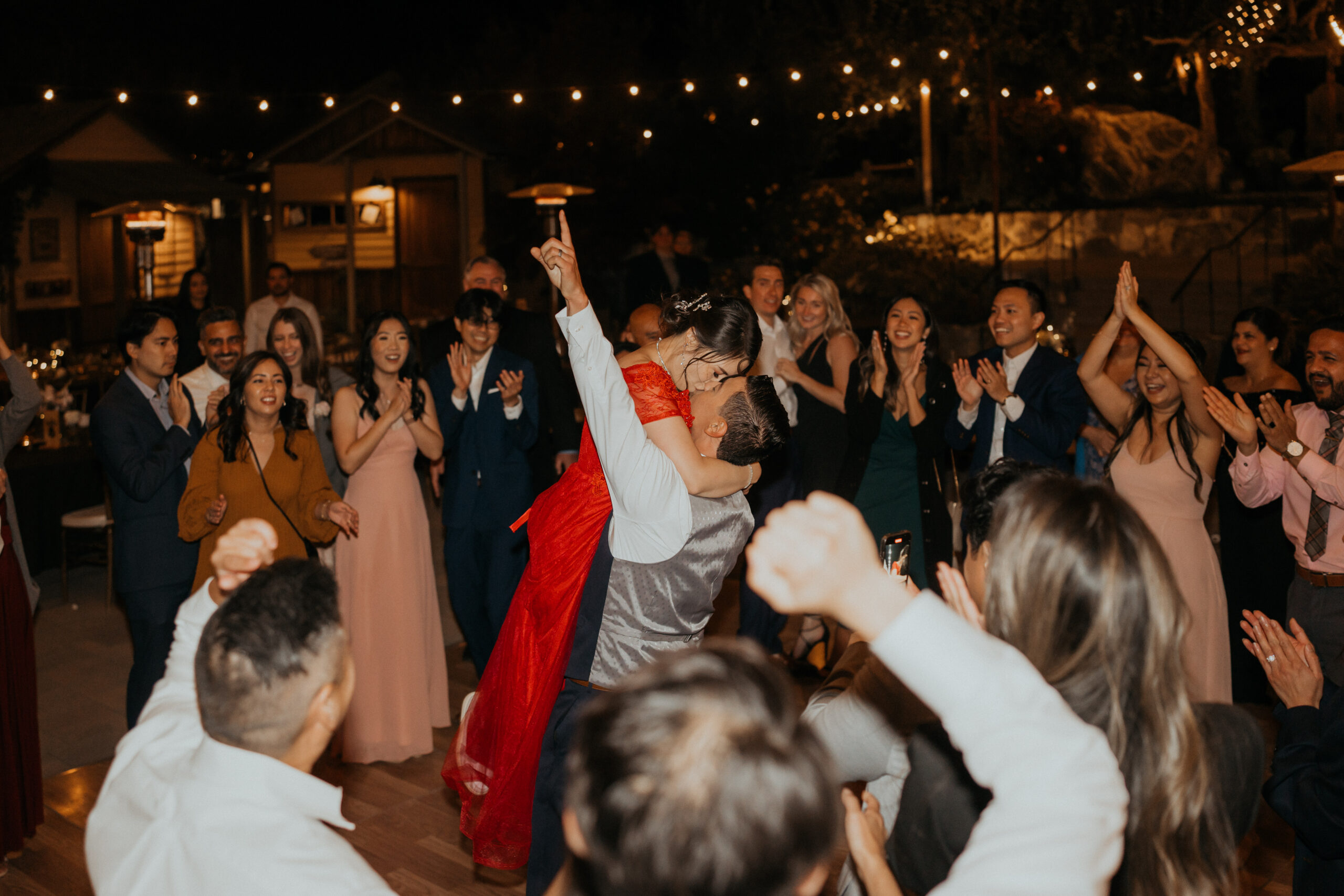 Bride and groom enjoying their last dance with wedding guests.